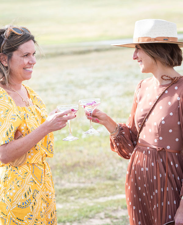 two women sharing drinks