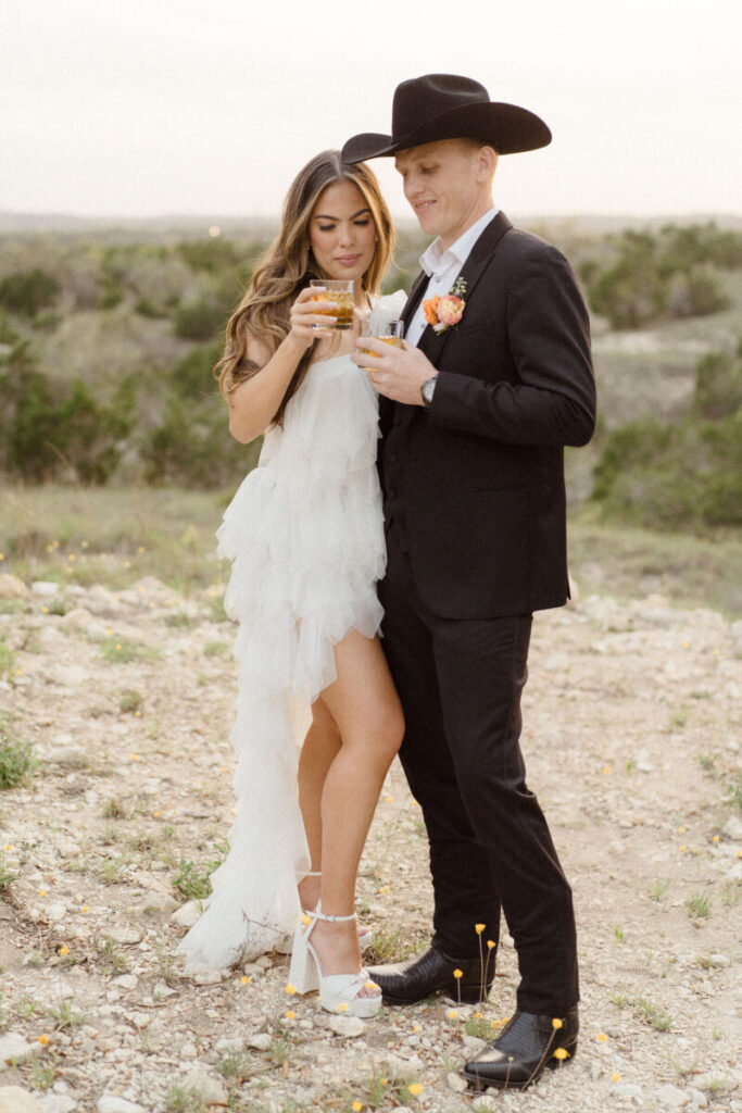 Wedding guests building their own cocktails at an interactive margarita bar