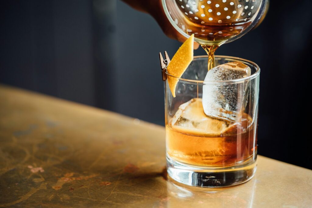 Ember and Orange Old Fashioned seasonal cocktail with whiskey and expressed orange garnish