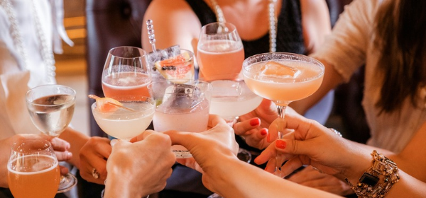 Guests toasting with cocktails at a Peak Beverage event