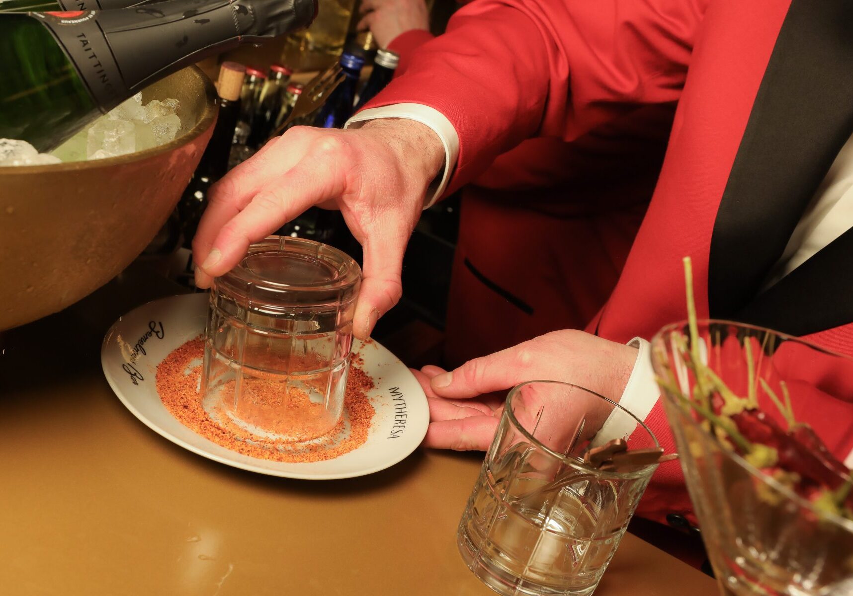 Hand dipping a glass rim into the salt scaled